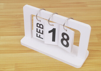 February, 18 on calendar on wooden table close-up.	