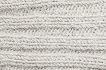 Naklejka na ściany i meble Close-up of a knitted fabric in the color Cloud Dancer, a soft neutral