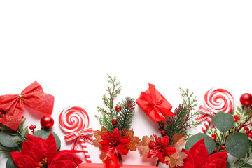 Composition with Christmas poinsettia flowers, lollipops and gift box isolated on white background