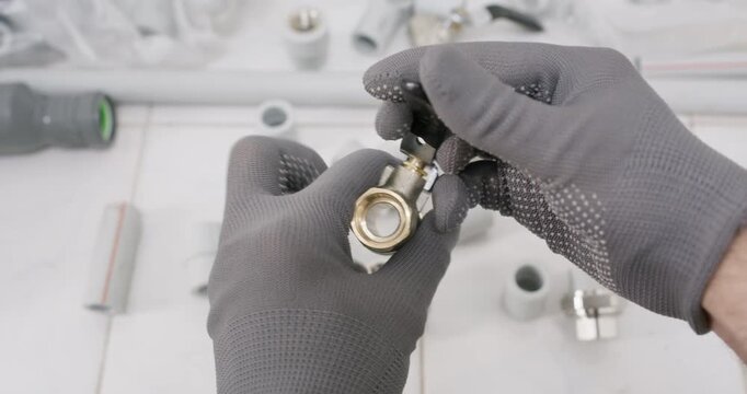 Assembler tightens lever on stem of ball valve with tool. Plumber sets stop position and secures nut verifying smooth quarter turn actuation while torque meets spec