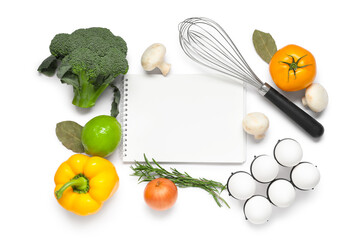 Composition with blank recipe book, whisk and fresh vegetables isolated on white background