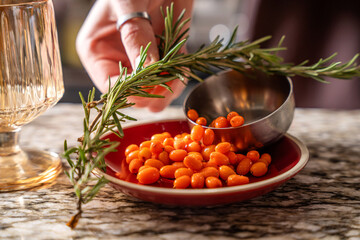 Sea buckthorn berries with fresh rosemary