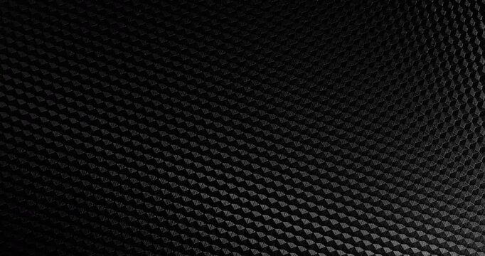 Carbon Texture Seamless Loop. Close-up of premium black carbon fiber weave with subtle light shift, creating a high-tech, endlessly background.