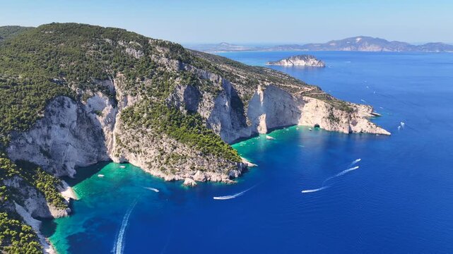 Aerial drone cinematic video of paradise sea caves of Keri with white cliffs and spectacular landscape creating a blue lagoon a true tourist attraction for yachts and boats, Zakinthos, Ionian, Greece