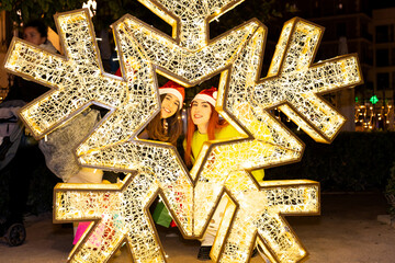 Gen z girls celebrating christmas shopping in valencia