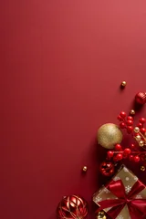 Gordijnen Gekleurd Glas A vertical rich red holiday scene with glittering ornaments, gold accents, a wrapped gift and red berry clusters. Ideal for Christmas and New Year greetings  © ActionGP