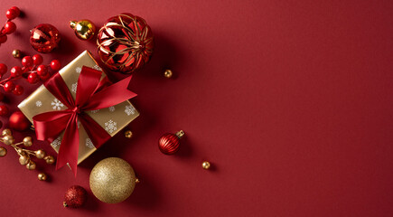 A festive holiday banner scene features a gold gift box with red ribbon, red berries, and gold...