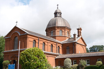 Red Brick Catholic Church of St. Laurence Exterior with Copper Dome and Surrounding Gardens, Petersfield