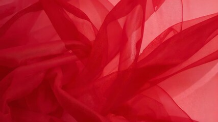 Settling single red translucent fabric revealing layered folds in close-up, lighter panel behind - Powered by Adobe