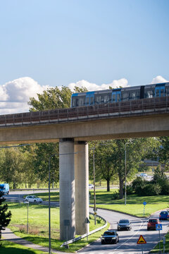 Modern urban mobility with a tram crossing infrastructure in Stockholm, Sweden, reflecting efficient transport within a growing city network for reliable public transit