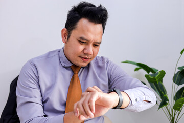 Focused Professional Checking Smartwatch for Urgent Updates