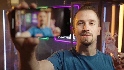 Anime influencer talking about girl figurine recording video with smartphone