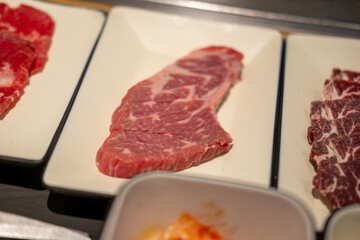 Korean Style Barbecue on plate. BBQ rare meat with soft focus