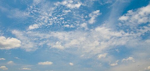 Vibrant Daytime Sky With Wispy Cirrus and Puffy Cumulus Clouds Across Horizon Horizontal