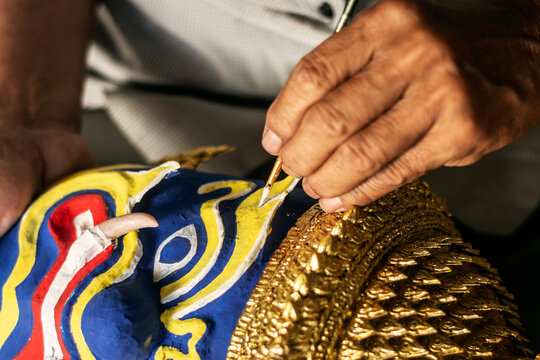 close up of artist painting lakhon khol traditional mask in cambodia