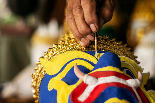 close up of artist painting lakhon khol traditional mask in cambodia