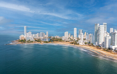 Fototapeta premium Aerial drone view of Cartagena Bocagrande skyline with sandy beach and blue Caribbean Sea on sunny day