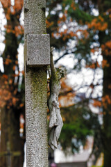 Weathered Stone Crucifix with Autumn Background