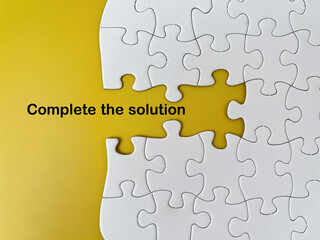 Missing puzzle piece concept with text &lsquo;Complete the solution&rsquo; on yellow background representing problem solving and strategic connection.