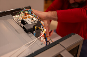 Mature Man Repairing Electronics