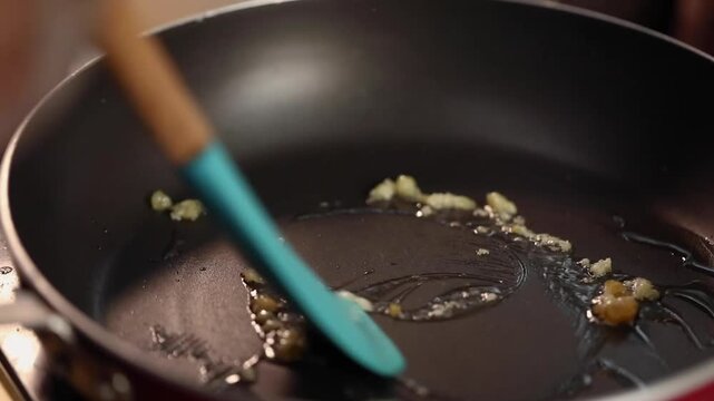 Roasting chopped ginger garlic pieces.cooking in a pan.
