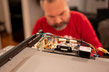 Mature Man Repairing Electronics