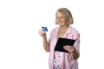 Senior woman holding credit card and tablet online shopping