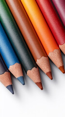 Set of sharpened multicolored pencils arranged closely on white background, representing creativity, art supplies, education and vibrant artistic expression in clean minimal style.