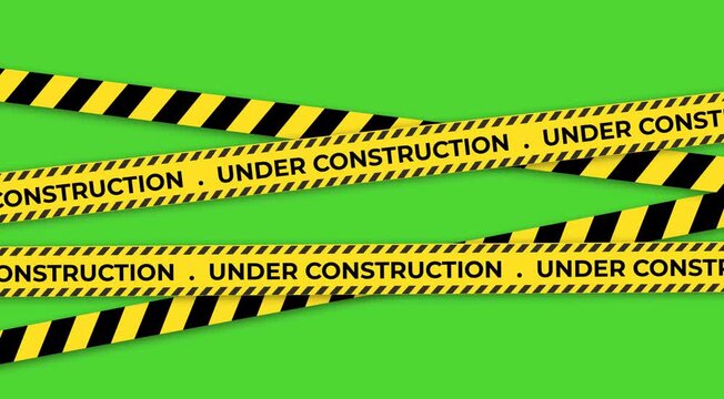 Cautionary yellow and black stripes tape overlaying a vibrant green background signifying ongoing construction or maintenance work