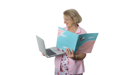 Senior woman learning using laptop and binder