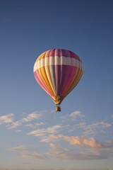 Fototapeta premium Single colorful hot air balloon against an open sky, serene aerial composition