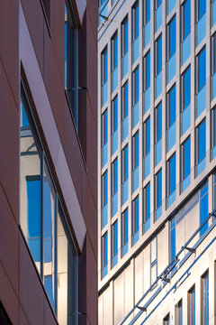 Geometry and reflection animate the architecture facade, creating a pattern where minimalism and contrast merge within a structure defined by clean lines and geometric design