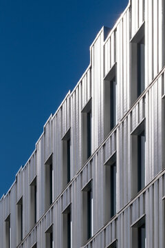 Architecture facade shaped by geometry and reflection features a pattern that aligns minimalism and contrast inside a structure guided by clean lines and geometric design