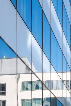 Geometry and reflection define an architecture facade where pattern, minimalism and contrast reinforce a structure built around clean lines and geometric design