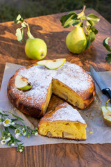Pie with pears with cut piece on brown background
