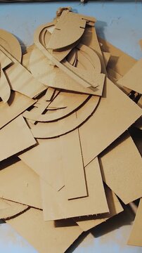 Vertical video. Template, plywood template. Plywood remnants after sawing. Element of carpentry work. Furniture production close-up, slow motion.