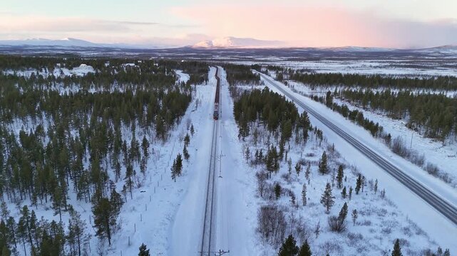 Aerial view of train on snow covered tracks, Sweden.