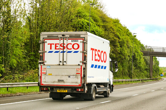 Taunton, England, UK - 23 April 2025: Rear view of a delivery lorry used by the Tesco supermarket chain, driving on the M5 motorway near Taunton.