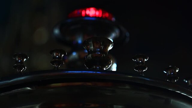 A detailed view of a clock face with a bright red light shining from behind, ideal for use in designs related to time, urgency or warning