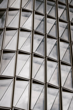 Architecture facade with pattern and repetition using geometry, glass, reflection, structure, symmetry and abstract pattern in a balanced visual frame