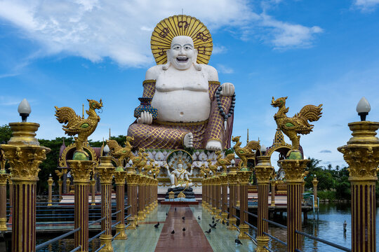 Smiling Buddha statue at Wat Plai Laem temple in Koh Samui, Thailand