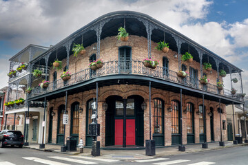 NOLA architecture, brick wall building with balconies and columns in a street of the French Quarter, New Orleans, Louisiana