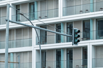 A green traffic signal is visible near modern residential units, emphasizing the harmony of urban living combined with efficient transportation and safety.