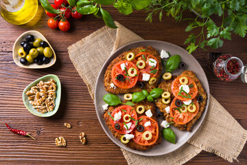 Breaded pork chop in tomatoes. Served with olives and feta cheese.