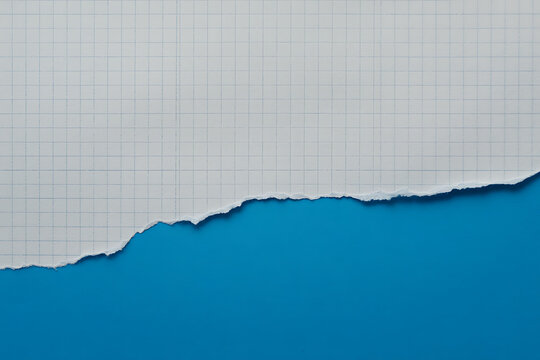 Torn piece of white lined paper revealing a vibrant blue background, creating a dynamic contrast