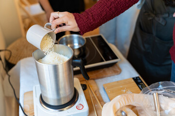 Woman making natural aromatic soy candles in workshop