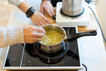 Women learning to create natural aromatic soy candles