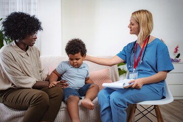 Fototapeta premium Caring doctor listening to family concerns