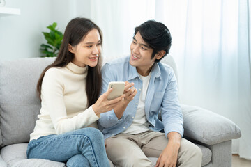 Couple using smartphone for online shopping at home. Hand holding mobile phone with payment detail page display and credit card, stay home, technology, electronic commerce, internet, market place