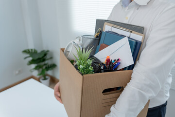 Stressful businessmen will resign from the company. lifting a brown paper box that holds personal...